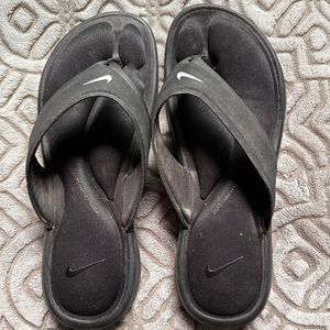 Slightly worn Nike flip flops